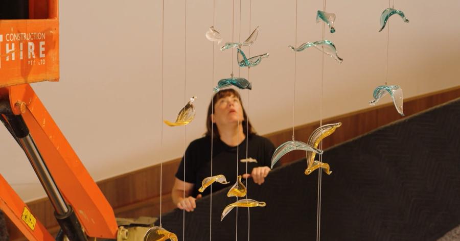 Annette Blair during the install of Quiet Skies sculpture