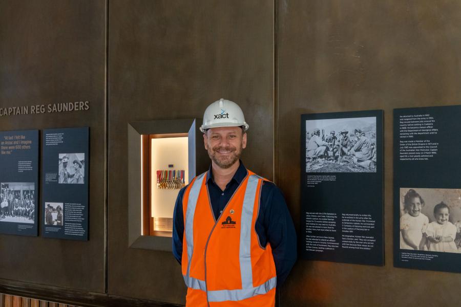 Memorial curator, Garth O'Connell, stands with the Captain Reg Saunders display.