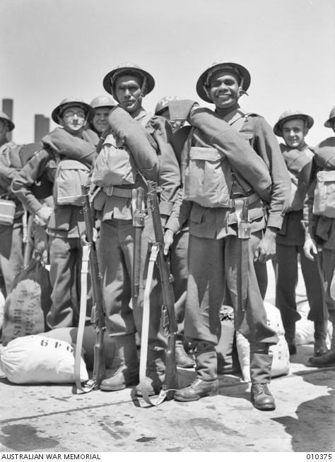 Informal portrait of two Aboriginal servicemen, NX43504 Private (Pte) George Leonard and NX43500 Pte Harold West, 14th Reinforcements to the 2/1st Battalion, embarking at Sydney.