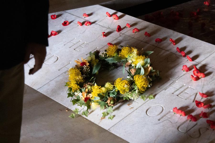 a person lays a wreath upon the tomb of the unknown australian soldier