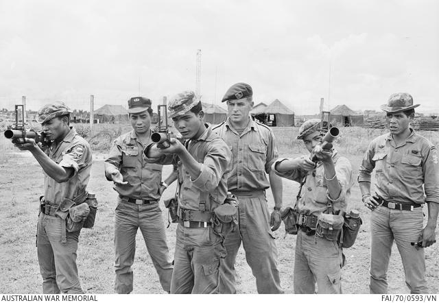 Pleiku, South Vietnam. July 1970. South Vietnamese Army Captain Siu Ddow and Australian Army Training Team Vietnam (AATTV) adviser, Warrant Officer Class 2 Jim Calcutt of East Reservoir, Vic, train Montagnard soldiers at the 2nd Mobile Strike Force base in central South Vietnam. They are teaching the soldiers how to use an M79 grenade launcher.