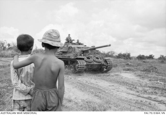 Two Vietnamese children watch a Centurion tank of A Squadron, 1st Armoured Regiment 