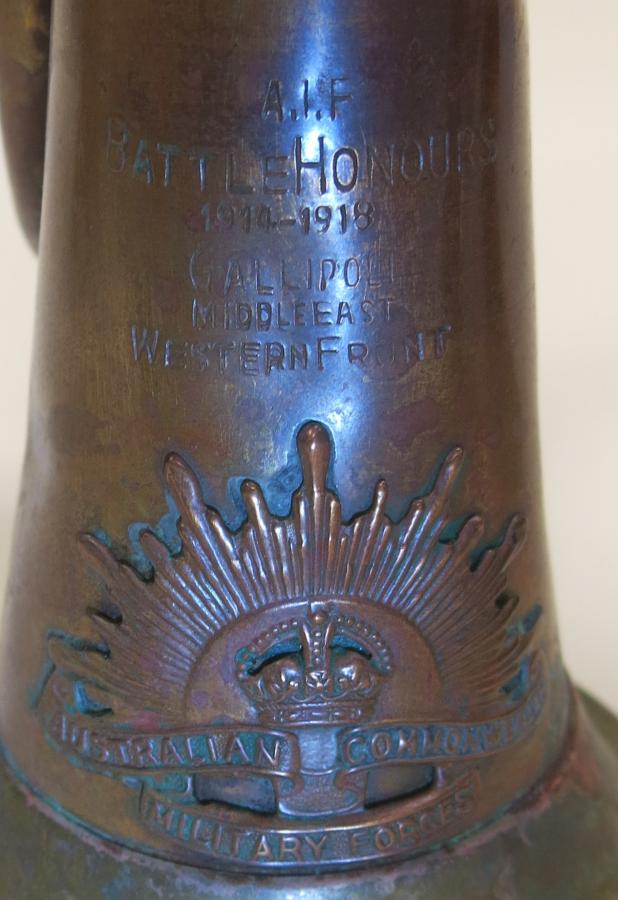 Stamped bugle with a rising sun badge