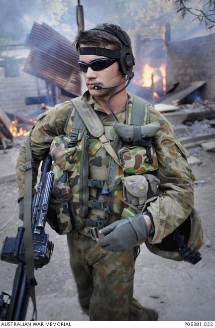 "David Dare Parker, Private Anthony Meixner, A Company, 1RAR, assisting bombeiros [firefighters], Dili, 7 June 2006 P05381.022"