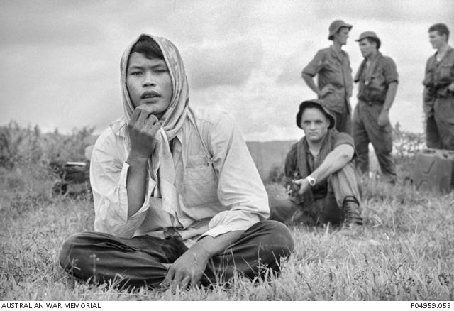 "Tim Page, A soldier of 1RAR guarding a suspected Viet Cong operative outside the 1st Australian Task Force base at Nui Dat, 1966 P04959.053"