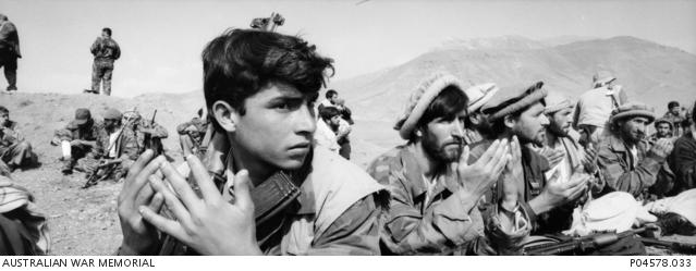 "Stephen Dupont, New recruits for the Northern Alliance praying before battle in Jabal os Saraj, Afghanistan, October 2001 P04578.033"