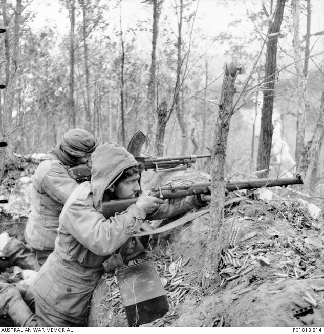 "Ian Robertson, Members of 3RAR in a shallow trench, Hill 614 area, February 1951 P01813.814"