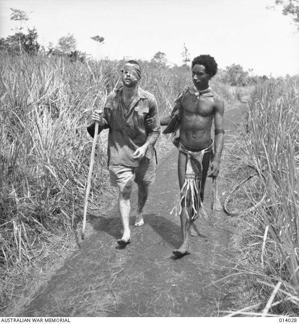 "George Silk, A “fuzzy wuzzy angel” leads a wounded Australian to a base hospital in the Buna area, 1942 014028"