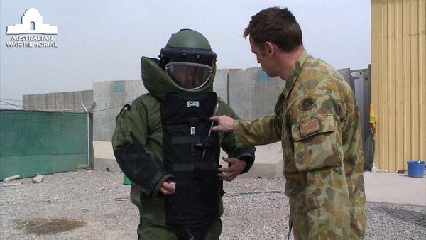Captain Andy Cullen the Australian Ordnance Explosive Device (OED) troop commander instructing AWM official artist Ben Quilty