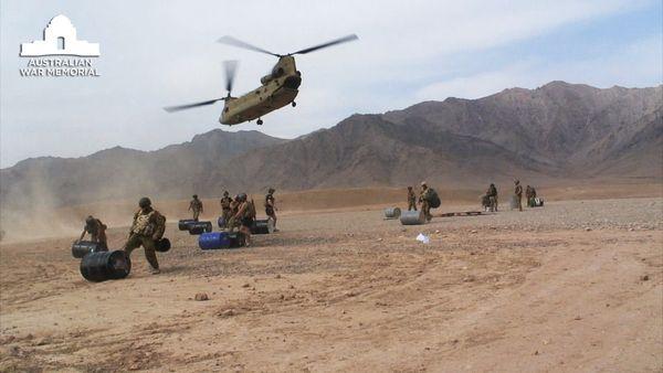 A US Army Chinook helicopter lifts off after making a supply drop of fuel for the base’s generators