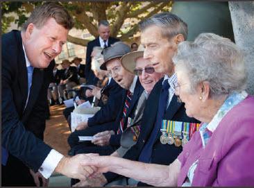 a photograph of Senator the Honourable Michael Ronaldson, Minister for Veterans' Affairs, greets patrons attending Annual Anzac Aged Care Wreathlaying Ceremony 2014, Western Courtyard, Australian War Memorial