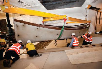 A photograph showing workers working on a boat for the new galleries
