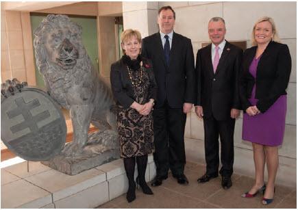 a photograph of The Australian War Memorial's Corporate Management Group in front of one of the Menin Gate lions before the statues were transported on loan to the Canadian War Museum