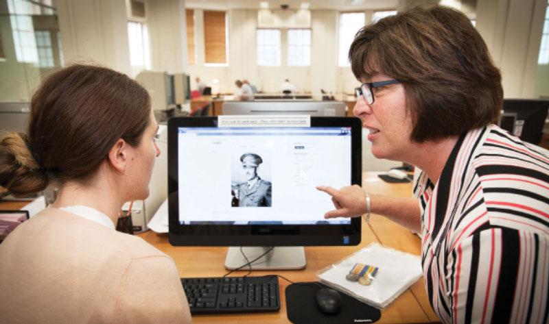 Jennifer Milward assists a client with family research