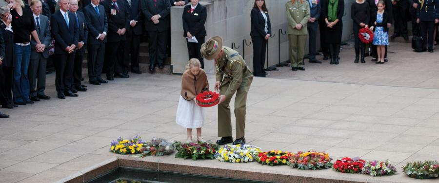 Members of the public lay a wreath together at the Last Post Ceremony