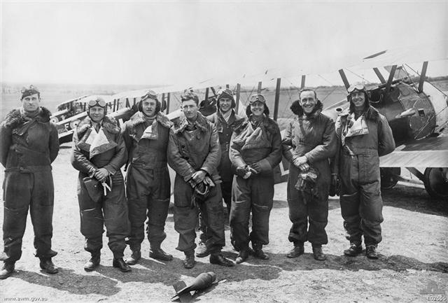 Group portrait of Officers of C Flight, No. 4 Squadron, AFC in full flying gear, about to take to the air.