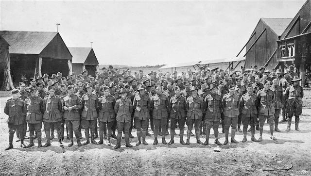 Group portrait of the Air Mechanics of No. 4 Squadron, Australian Flying Corps (AFC), at the hangars at Clairmarais, 16 June 1918.