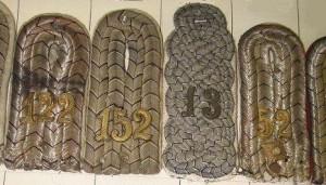 RELAWM15049.002 : A selection of German officers' shoulder boards. The outer two boards are made with silver braid, while the inner two are made from grey fabric