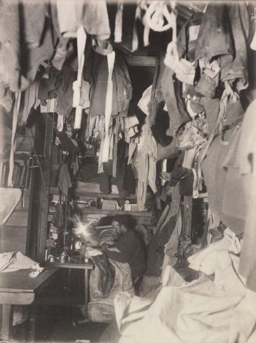 Bage mending his sleeping bag in “Mawson’s hut”, during the Antarctic expedition.