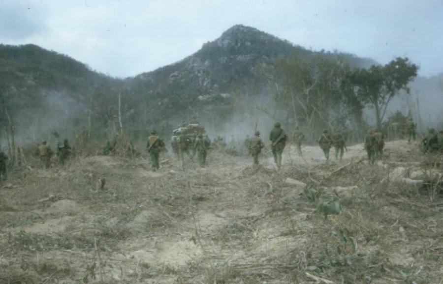 Nearing the Long Hais, the soldiers of 8RAR dismounted from the APCs and advanced in artillery formation with the tanks. The continuing threat of mines meant each soldier wore a flak vest and helmet. Photo: Rod Simpson.