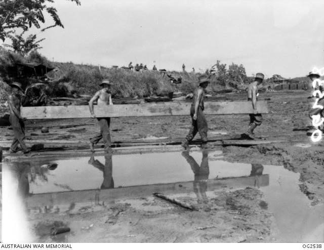 The beach on Tarakan was a difficult area for unloading and RAAF engineers had to corduroy the mud with heavy lengths of timber between the end of the floating ramps and the shore.  