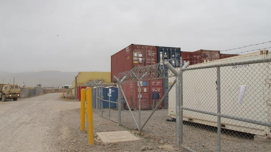 razor wire, shipping containers dusty roads