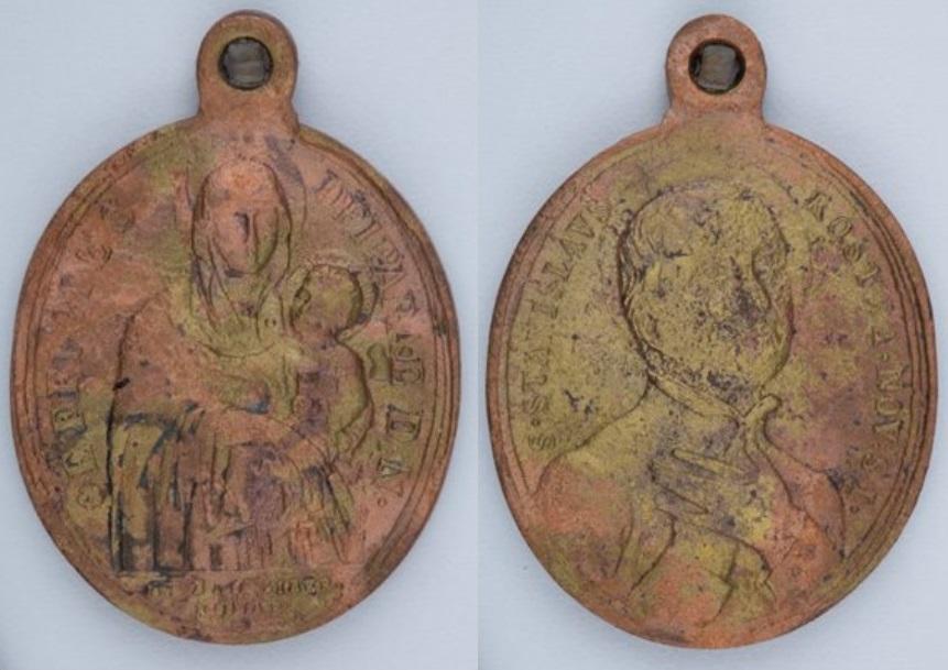 REL44975.086 Religious medallion found with the rosary.