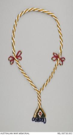 A necklace with a spiral design in gold and white.