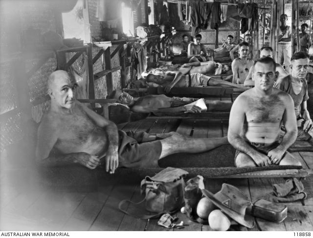 Chronically ill patients whose health broke down in the Burma and Thailand jungle during the construction of the railway, in Ward 19 of Nakom Paton Hospital (September 1945). Photograph by Norman Stuckey. 