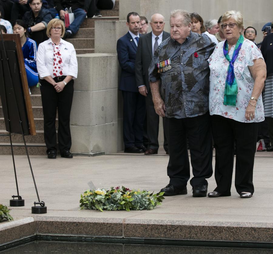 Bill and his wife lay a wreath in honour of his father and uncle.
