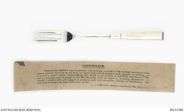 Silver fork with a paper certificate sitting underneath
