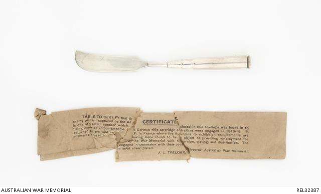 Silver knife with certificate underneath
