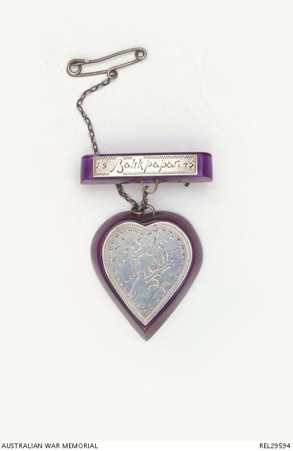 This sweetheart brooch was made by Sergeant Thomas Martin, RAAF, in 1945 for his niece Judith. It was made using a purple toothbrush and pieces of engraved aluminium.