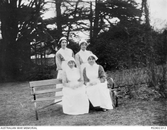 Four nurses in the grounds of the hospital