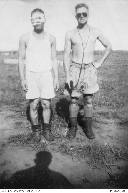 Sergeant Hajime Toyoshima with Sergeant Leslie J. Powell. The pistol that Powell is holding is Toyoshima's service pistol. 