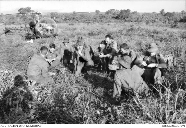 Major Harry Smith, far left, holds a briefing in the field shortly before his company return to the Long Tan battlefield. Second Lieutenant Dave Sabben is next to him.