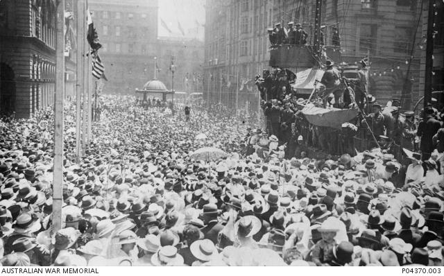 A large crowd gathered in Martin Place to celebrate Armistice Day. A replica sailing ship, festooned with lights has been set up like a stage for dignitaries to address the crown from.