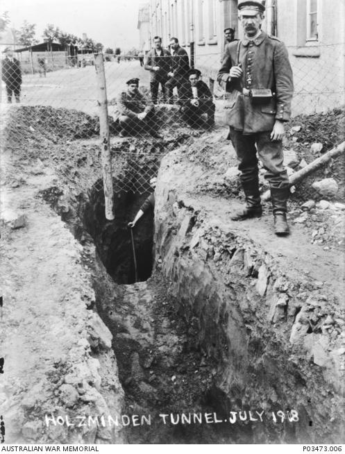 Two German guards inspect an exposed section of an escape tunnel leading from the Holzminden Prisoner of War Camp.