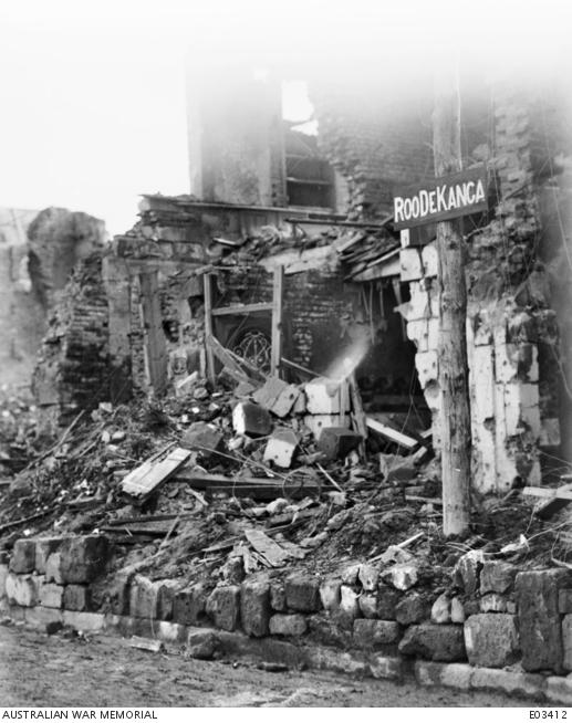 A sign amongst the rubble which reads "Roo de Kanga"