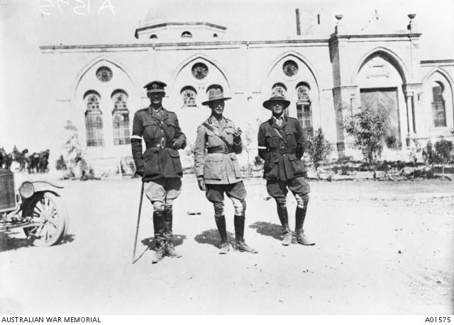 Informal portrait of General Sir H G Chauvel GOC, Desert Mounted Corps (centre) with Brigadier General R G H Howard-Vyse CMG DSO, his Brigadier General, General Staff (BGGS) (left) and Captain W G Lyons MC (right), one of his Aide de Camps (ADC). The previous day the town was captured as a result of a particularly audacious mounted charge by the 4th Light Horse Brigade.