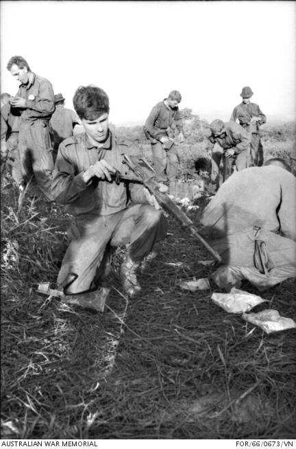 Second Lieutenant David Sabben with his damaged Armalite rifle after the battle of Long Tan.