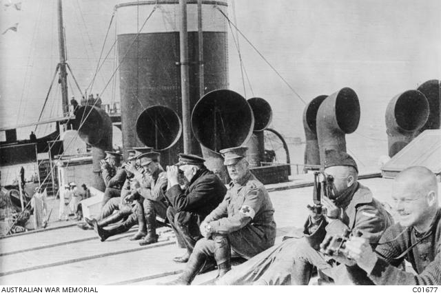 Seated on the deck of the troopship HMAT Mashobra sit officers of the 2nd Field Ambulance 