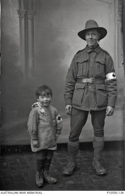 Portrait of 521 Lance Corporal (L Cpl) Robert Sumner, 6th Battalion, Australian Field Ambulance with Robert Thuillier, the photographer&#039;s son, dressed in a field ambulance costume.