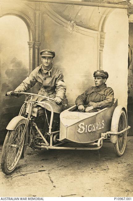 Portrait of Sergeant James Leonard Paddock MSM, left, Australian Corps of Signals, and Corporal Herbert Reginald Bain MSM, 1st Divisional Signal Company. Both men returned home to Australia in April 1919. The sidecar was made, by the men, out of parts from a damaged aeroplane, with the word 'signals' painted on the side.