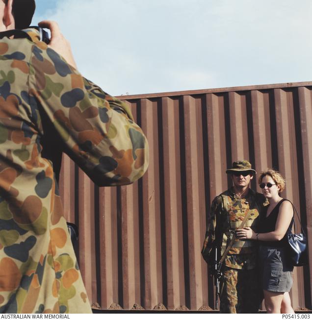 Man taking photograph of a couple