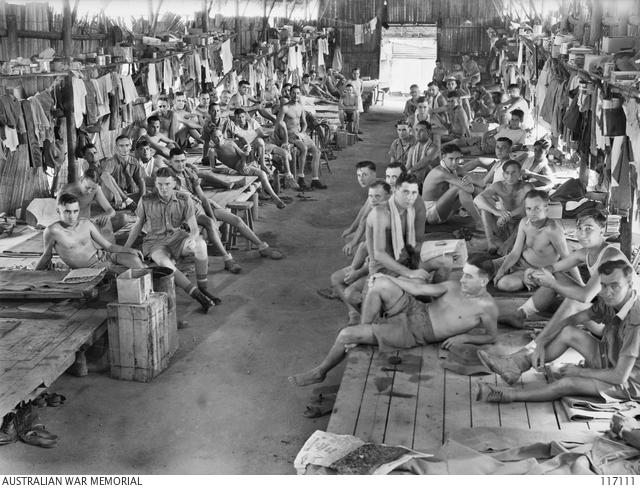 Personnel of C Company, 2/29th Battalion, in their hut at the rear of Changi Gaol, 1945.