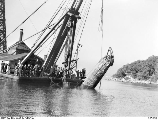 M-22 being raised by the bows from the Harbour by a floating crane, 10 July 1942.