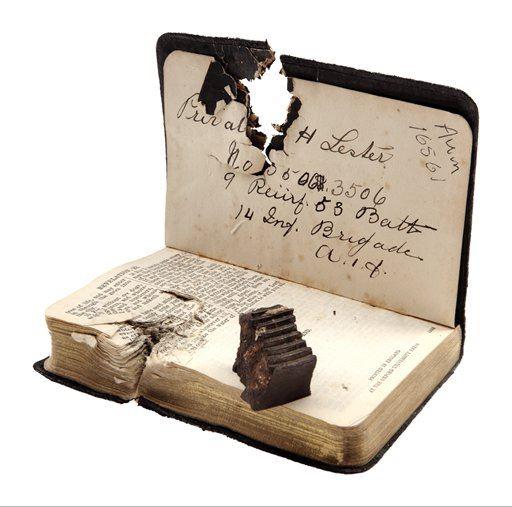 Pocket testament and shrapnel that damaged it
