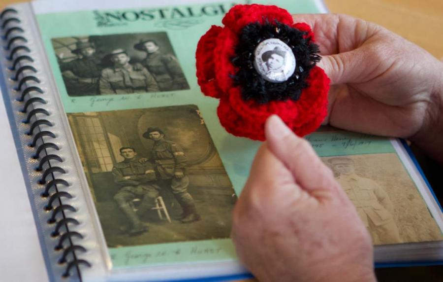 A knitted poppy for George Hurst and a photo album in the background