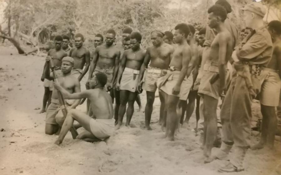 Jim with Papuan troops using the mortar gun.